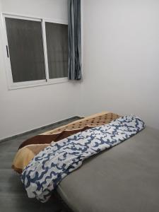 a bed in a room with a window at tamraght samba 2 in Tamraght Ou Fella