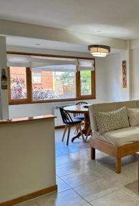 a living room with a couch and a table at Depto centrico soñado in San Martín de los Andes
