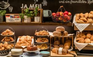 a bakery with different types of bread and pastries at Motel One Wien-Hauptbahnhof in Vienna
