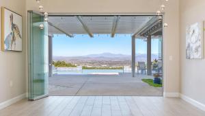 a glass door leading to a patio with a view at Summit Ranch by AvantStay in Temecula