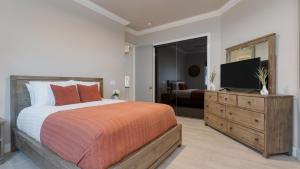 a bedroom with a large bed and a television at Summit Ranch by AvantStay in Temecula