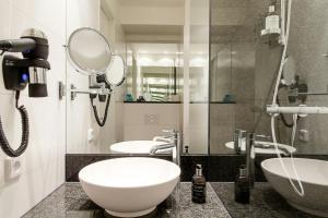 a bathroom with two sinks and a mirror at Motel One Manchester-Piccadilly in Manchester +25 photos
