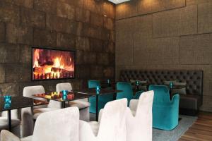 a restaurant with tables and chairs and a fireplace at Motel One Manchester-Piccadilly in Manchester
