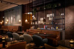a restaurant with tables and chairs and a bar at Motel One Dublin in Dublin +33 photos