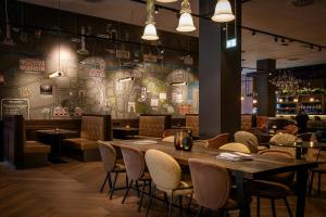 a dining room with a table and chairs at Motel One Dublin in Dublin