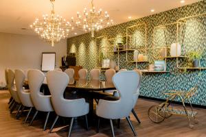 a conference room with a table and chairs at Motel One Essen in Essen