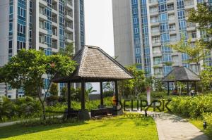a gazebo in a park with tall buildings at SheepDream 18DS DeliparkMall 2Bedroom, 1Bathroom in Medan
