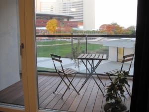 a balcony with a table and chairs on a deck at Apartment with parking on premise in Vienna