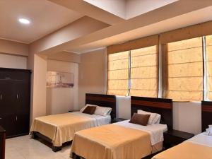 a room with two beds and two windows at Gran Hotel Ica in Ica +61 photos