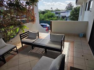 two chairs and a bench on a patio at BR Rooms in a Shared house in Kingston