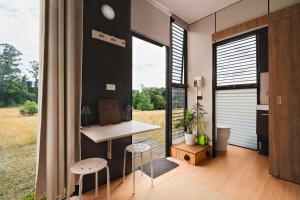 a home office with a desk and a large window at The Ridge by Tiny Away in Korweinguboora