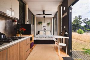 a tiny house with a bed in the middle at The Ridge by Tiny Away in Korweinguboora