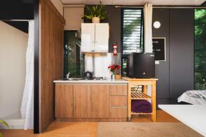 a kitchen with a sink and a microwave at The Ridge by Tiny Away in Korweinguboora