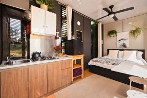 a kitchen with a bed and a sink in a room at The Ridge by Tiny Away in Korweinguboora