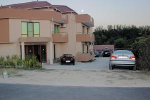 a group of cars parked in front of a building at Tangra Guest House in Arapya