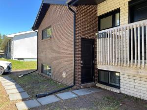a house with a black door on the side of it at Warm and Welcoming Basement in Dieppe
