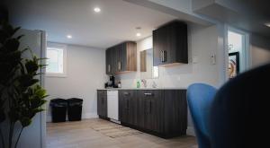 a kitchen with wooden cabinets and a counter top at Warm and Welcoming Basement in Dieppe