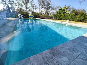a large swimming pool with blue tiles on theructure at Kitchaview Poolvilla พูลวิลล่า เชียงราย in Chiang Rai