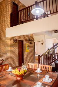 a table with a bowl of fruit on top of it at Casa triplex Lagoinha in Lagoinha +28 photos