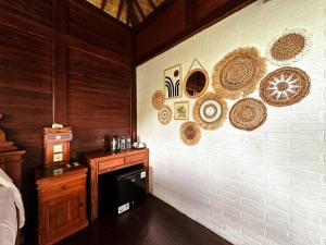a room with a wall with hats on it at Munduk V View House in Munduk