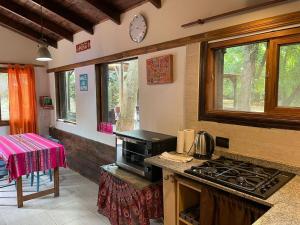 a kitchen with a stove and a stove top oven at Cabaña - El Bamboo Eventos in Arturo SeguÃ­