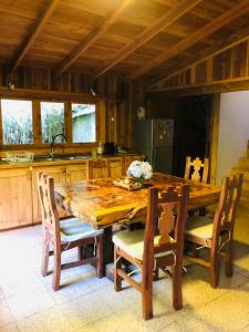 a wooden table and chairs in a kitchen at Logia Blanca in Villarrica