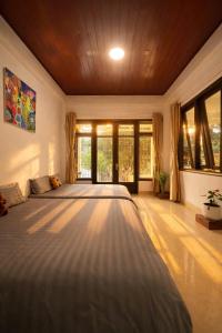 a large bedroom with two beds and windows at Umee Stayin Đà Lạt in Da Thanh