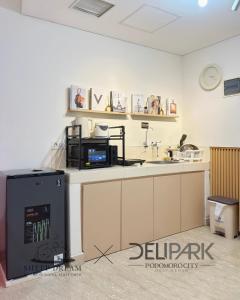 a kitchen with a sink and a microwave at SheepDream 17BC DeliparkMall 2Bedroom, 1Bathroom in Medan