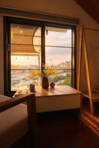 a table in front of a window with a view at Umee Stayin Đà Lạt in Da Thanh