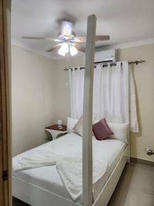 a bedroom with a bed with a ceiling fan at Amazing Three Bedrooms House in La Romana
