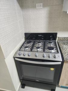 a black stove top oven in a kitchen at Amazing Three Bedrooms House in La Romana