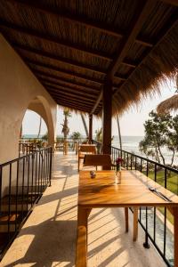 a patio with tables and a view of the ocean at Neem - Boutique Hotel Madiha - ADULTS ONLY in Kamburugamuwa