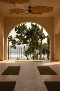 an empty room with a large window and a large yoga mat at Neem - Boutique Hotel Madiha - ADULTS ONLY in Kamburugamuwa