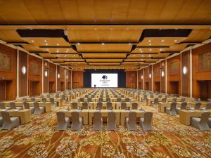 a large room with chairs and a projection screen at Doubletree By Hilton Sanya Bay in Sanya +165 photos