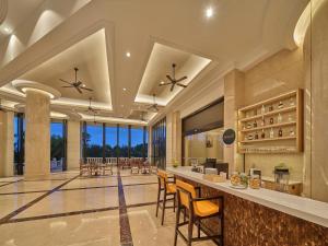 a lobby with a bar with chairs and tables at Doubletree By Hilton Sanya Bay in Sanya