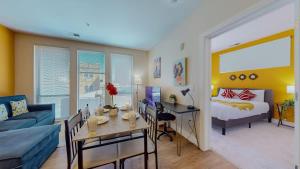 a living room with a couch and a bed and a desk at Stylish Home and Cozy200 in Stamford