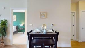 a dining room with a black table and chairs at Stylish Home with Free Parking in Stamford