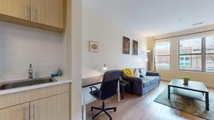 a kitchen and living room with a couch and a table at Stylish Home with Free Parking in Stamford