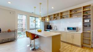 a large kitchen with a counter and a sink at Stylish Home and Cozy in Stamford