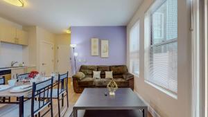 a living room with a couch and a table at Stylish Home and Cozy in Stamford