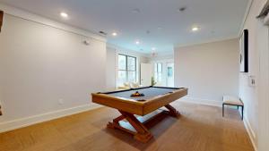 a billiard table in a room with a wall at Stylish Home and Cozy in Stamford