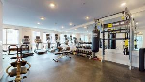 a gym with a bunch of equipment in a room at Stylish Home and Cozy in Stamford +21 photos