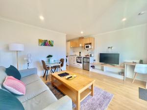 a living room with a couch and a table at Star View in Lake Tekapo