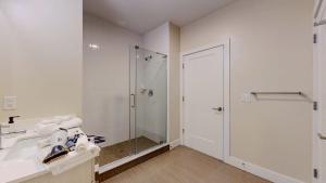 a white bathroom with a shower and a sink at Great Charming stay in Stamford
