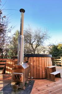 a wood stove on a deck with a wooden fence at Former Hotel Transformed Into Chalet In Valmorel in Les Avanchers