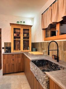 a kitchen with a sink and a counter top at Former Hotel Transformed Into Chalet In Valmorel in Les Avanchers +29 photos