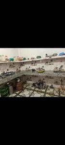 a shelf filled with lots of toy cars on it at Mishthi singh homestay in Jalālpur Dhai