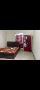 a small room with two beds and a window at Mishthi singh homestay in Jalālpur Dhai