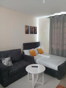 a living room with a couch and a coffee table at Machakos Town Studios in Machakos