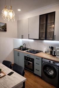 a kitchen with a stove and a dishwasher at Chill House in Kutaisi +24 photos